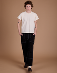 Quinn is 6’3” and wearing M Carpenter Jeans in Black paired with the Organic Vintage Tee in Vintage Tee Off-White