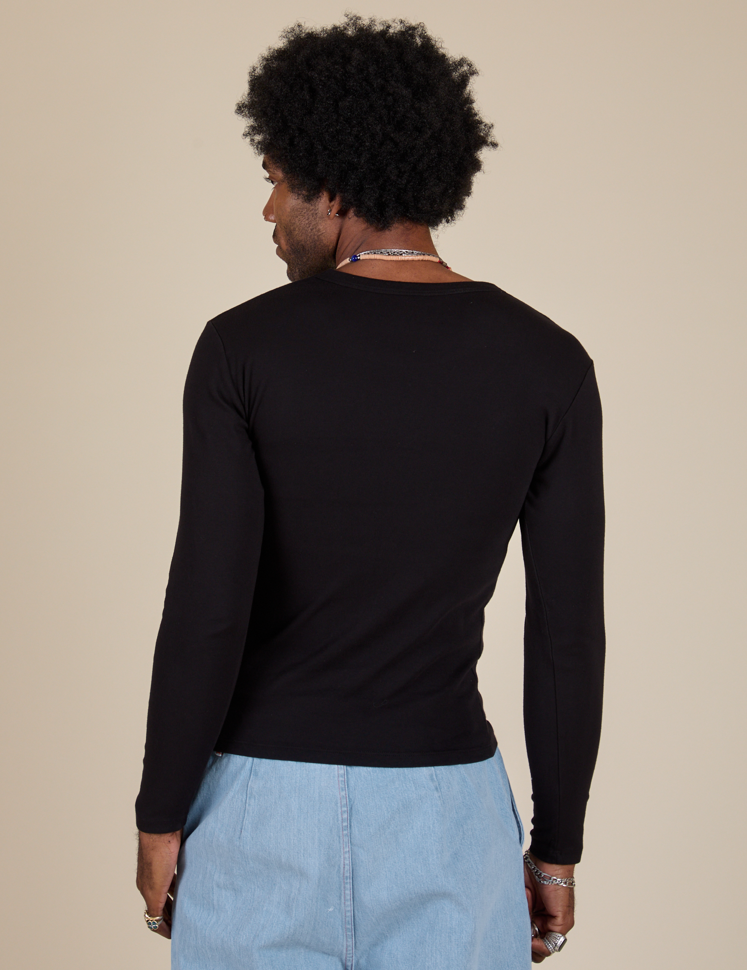 Long Sleeve Baby Tee in Basic Black back view on Jerrod