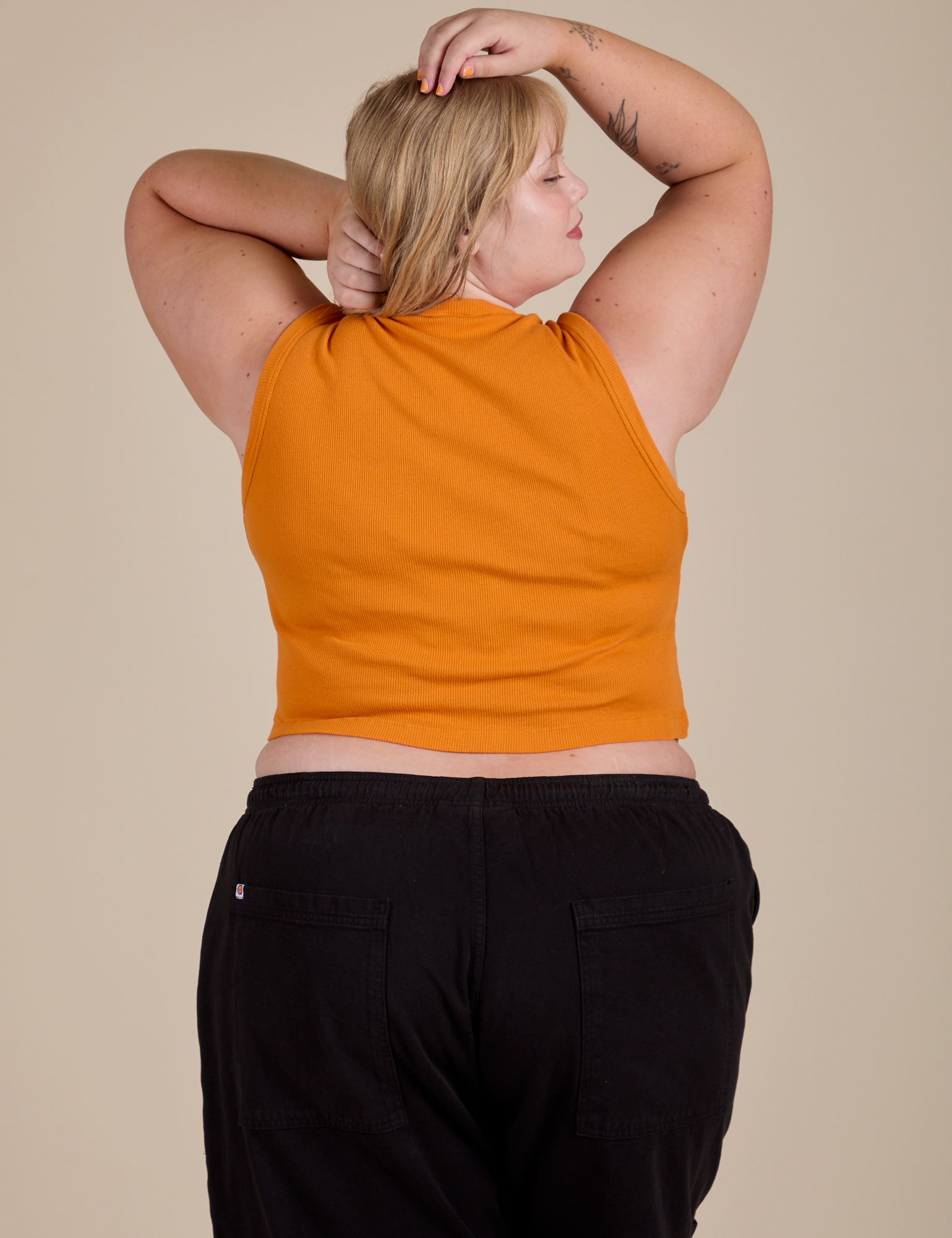 Muscle Tee in Creamsicle Orange back view on Juliet