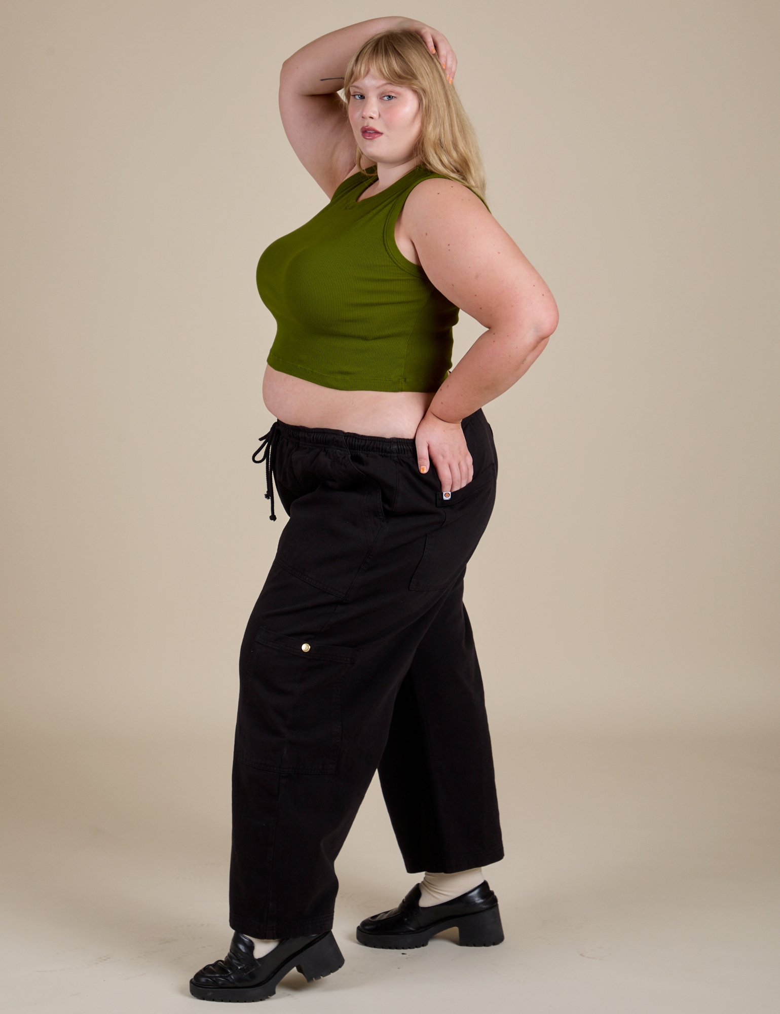 Side view of Muscle Tee in Summer Olive on black Drop Pocket Cargo Pants on Juliet