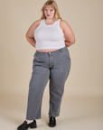 Juliet is wearing Racerback Tank in Vintage Tee White and washed grey Work Pants