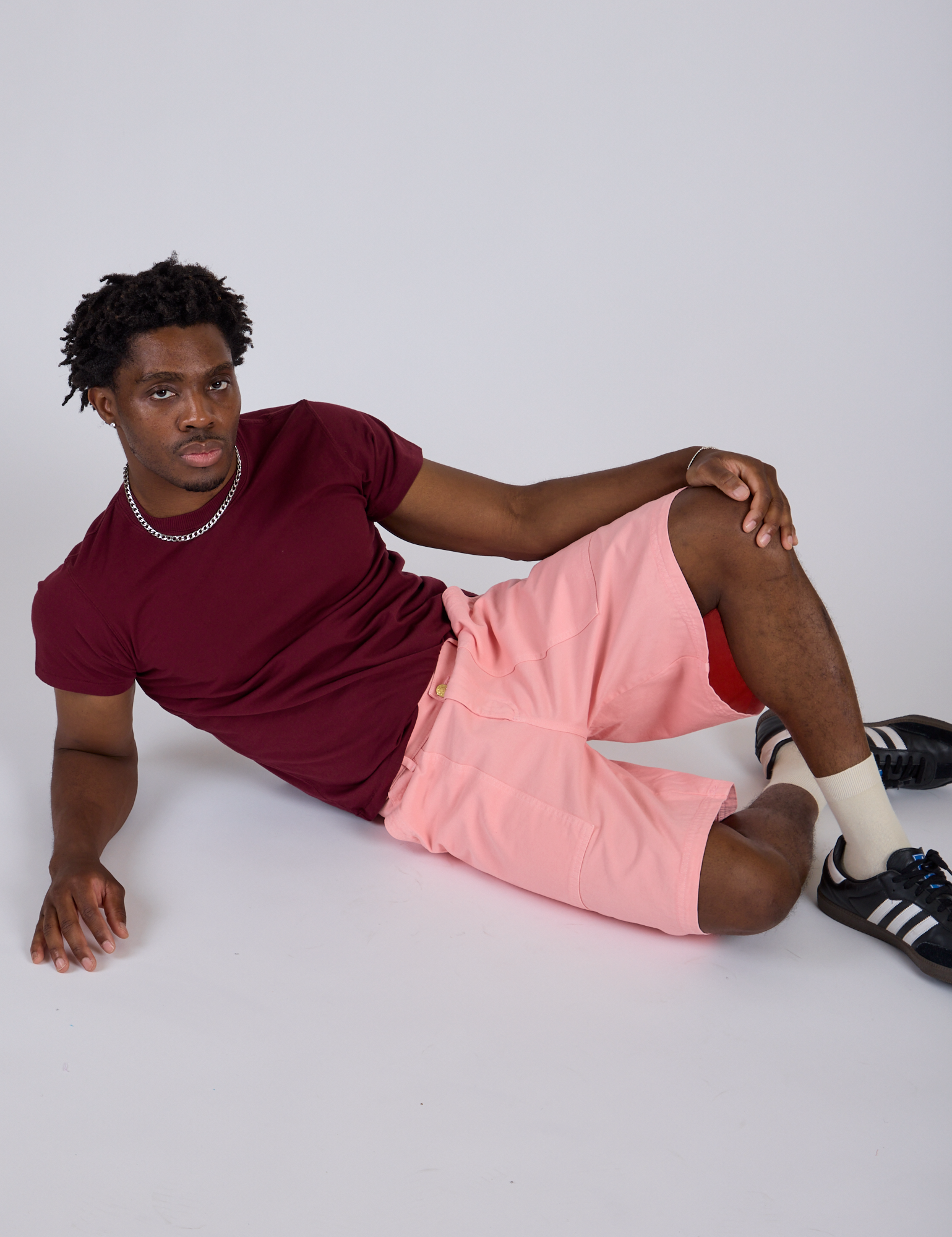 Isaac is wearing Longline Work Shorts in Baby Pink and Organic Vintage Tee in Red Wine