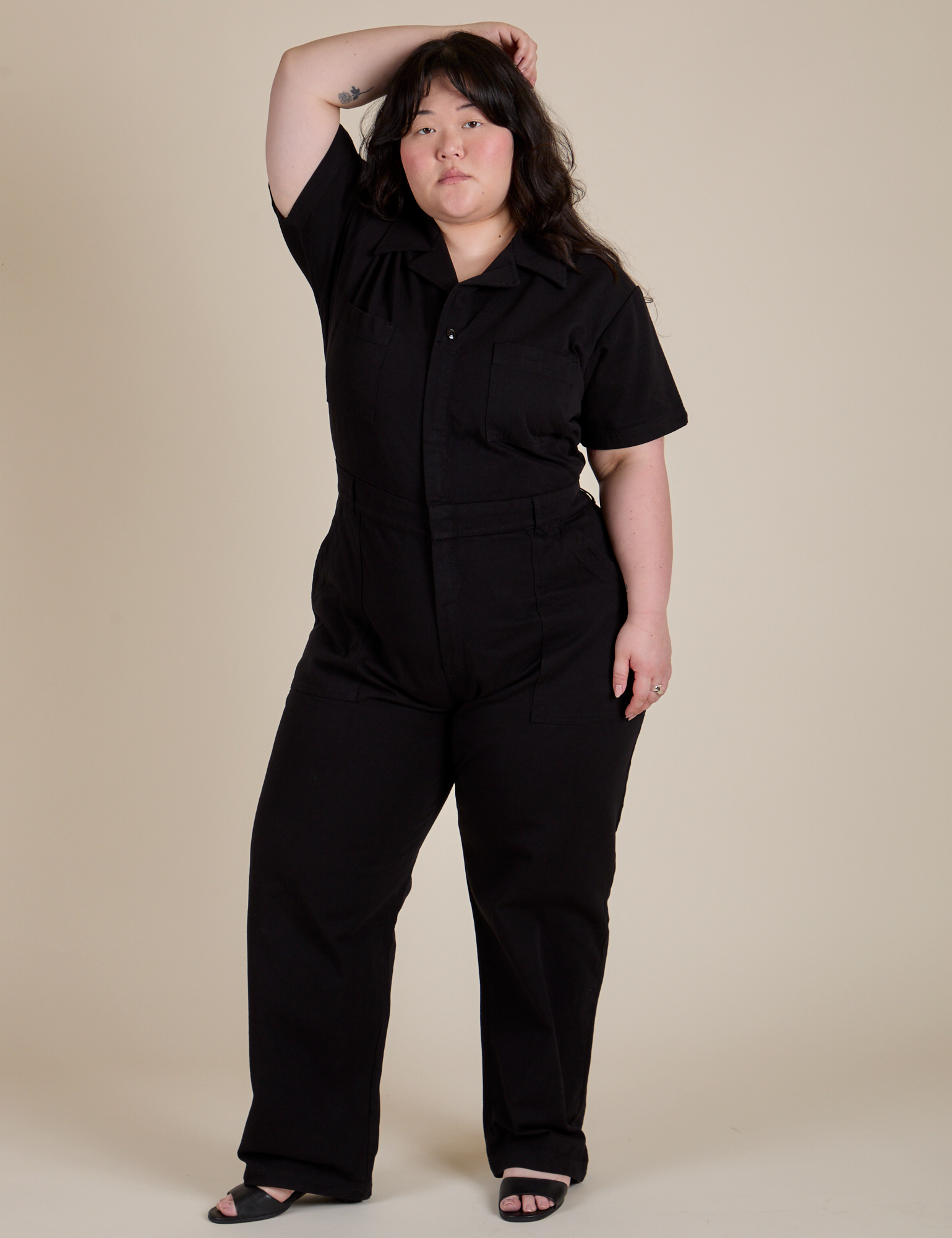 Ashley is 5'7" and wearing 1XL Short Sleeve Jumpsuit in Basic Black