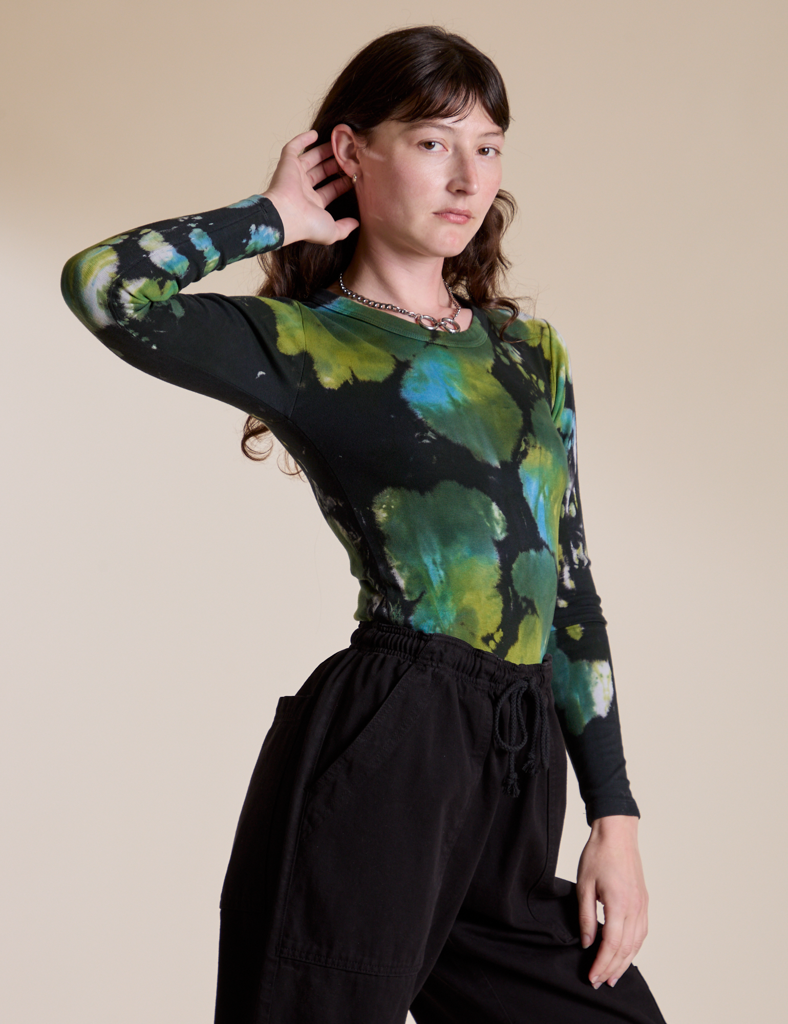 Angled front view of Long Sleeve Baby Tee in Green Pool on Alex