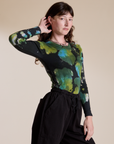 Angled front view of Long Sleeve Baby Tee in Green Pool on Alex