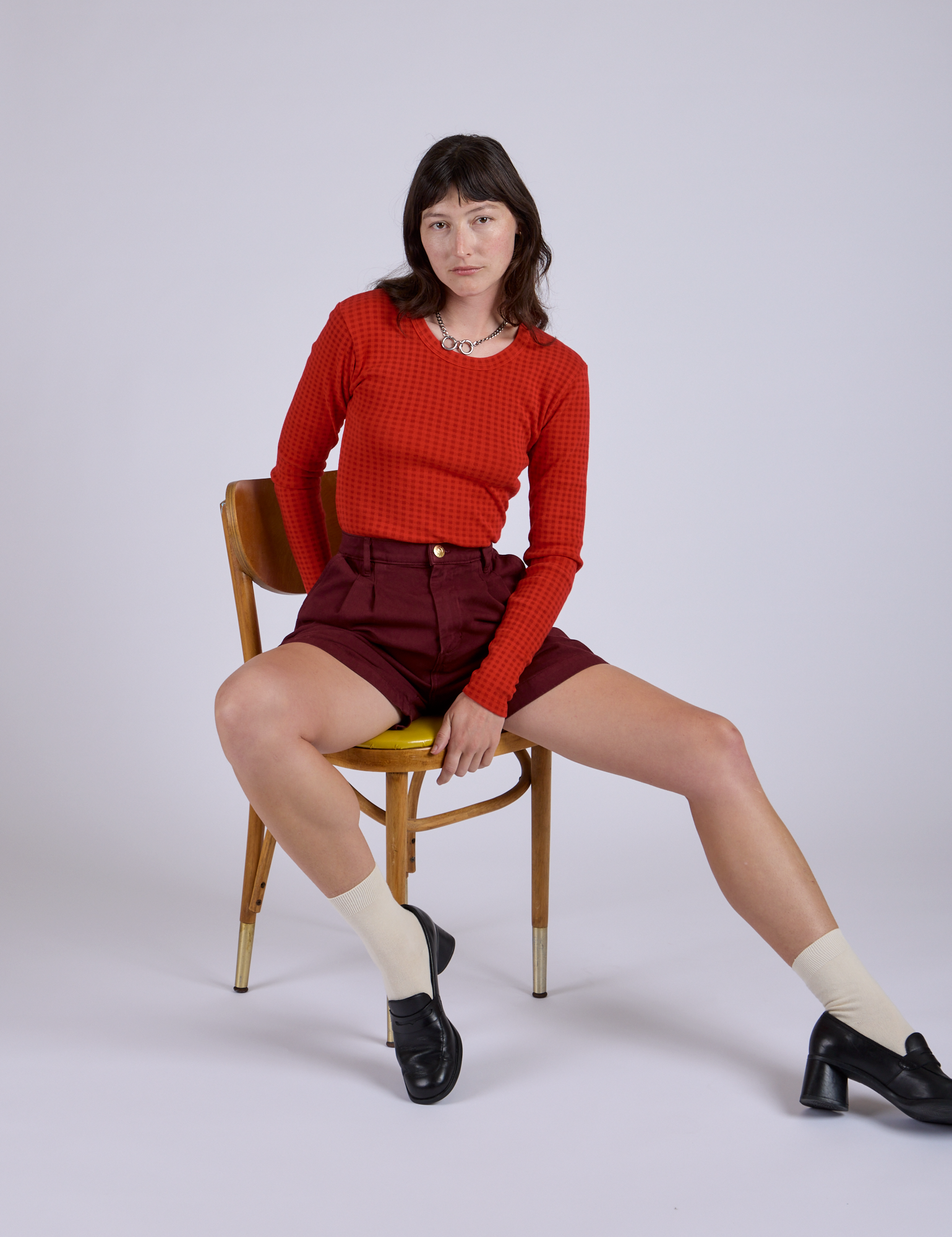 Pleated Trouser Shorts in Red Wine and mustang red Long Sleeve Gingham Baby Tee on Alex
