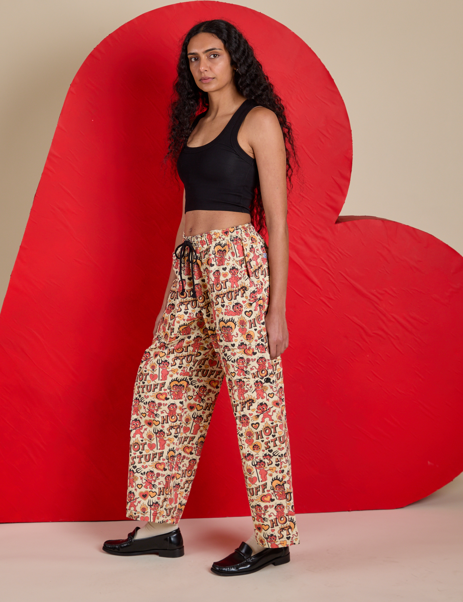 Side view of Hot Stuff Drop Pocket Cargo Pants and black Cropped Tank on Shahana