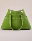 Overall Handbag in Bright Olive with handle strap down 