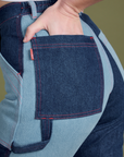 Close up of Alex's hand in the back pocket of Mismatched Denim Carpenter Jeans