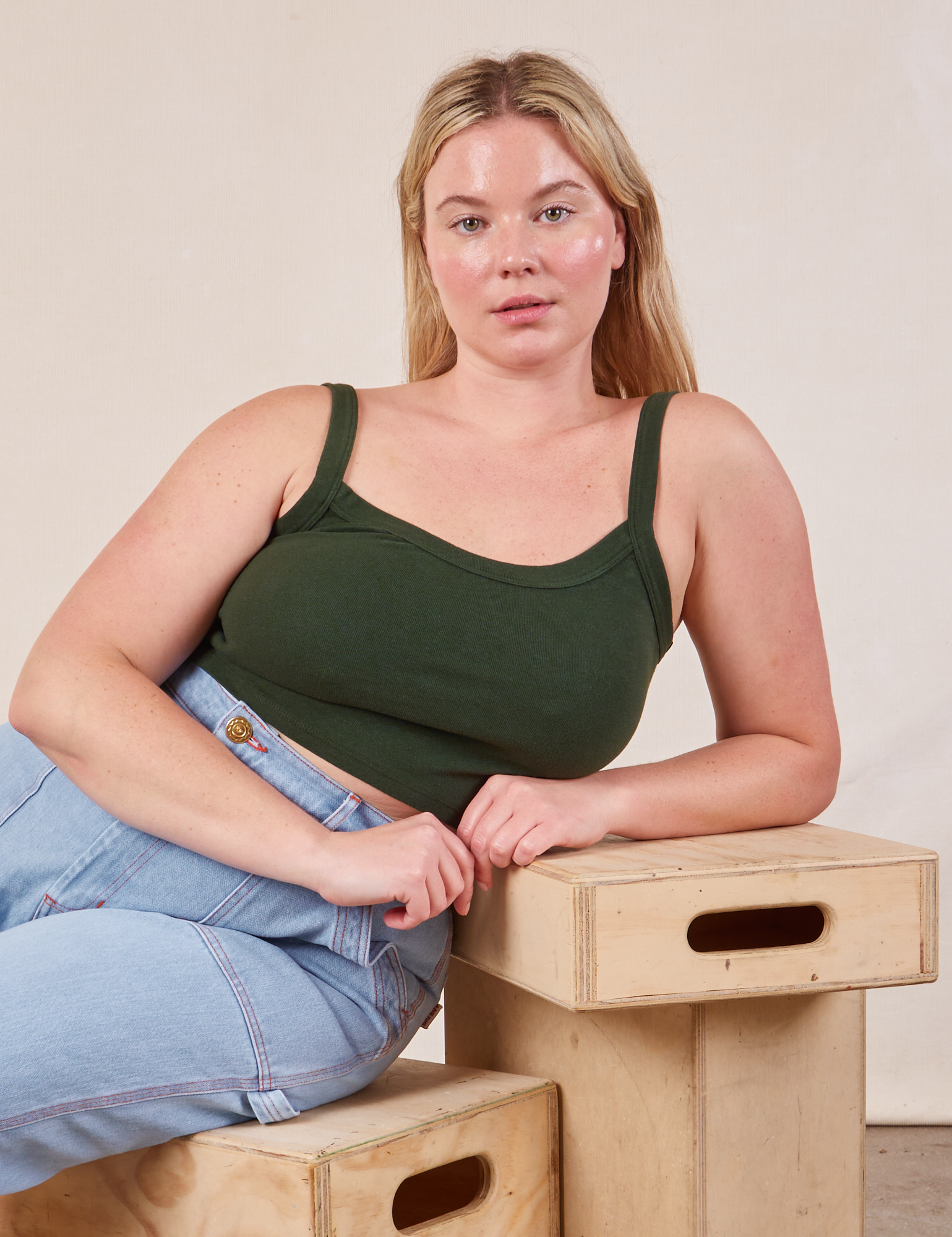 Lish is wearing Cropped Cami in Swamp Green and lightwash Carpenter Jeans