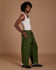 Side view of Drop Pocket Cargo Pants in Evergreen and Tank Top in vintage tee white on Jerrod