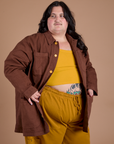 Angled front view of Ripstop Field Coat in Fudgesicle Brown on Sam