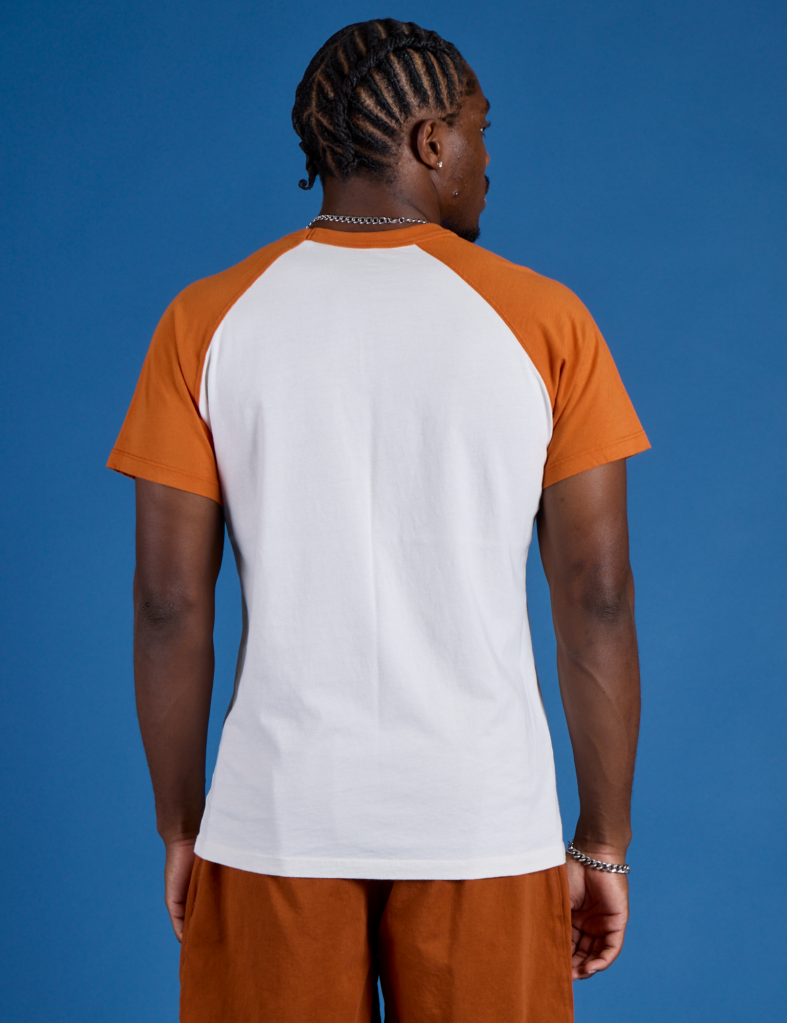 Back view of Produce Raglan Tee in Orange on Isaac