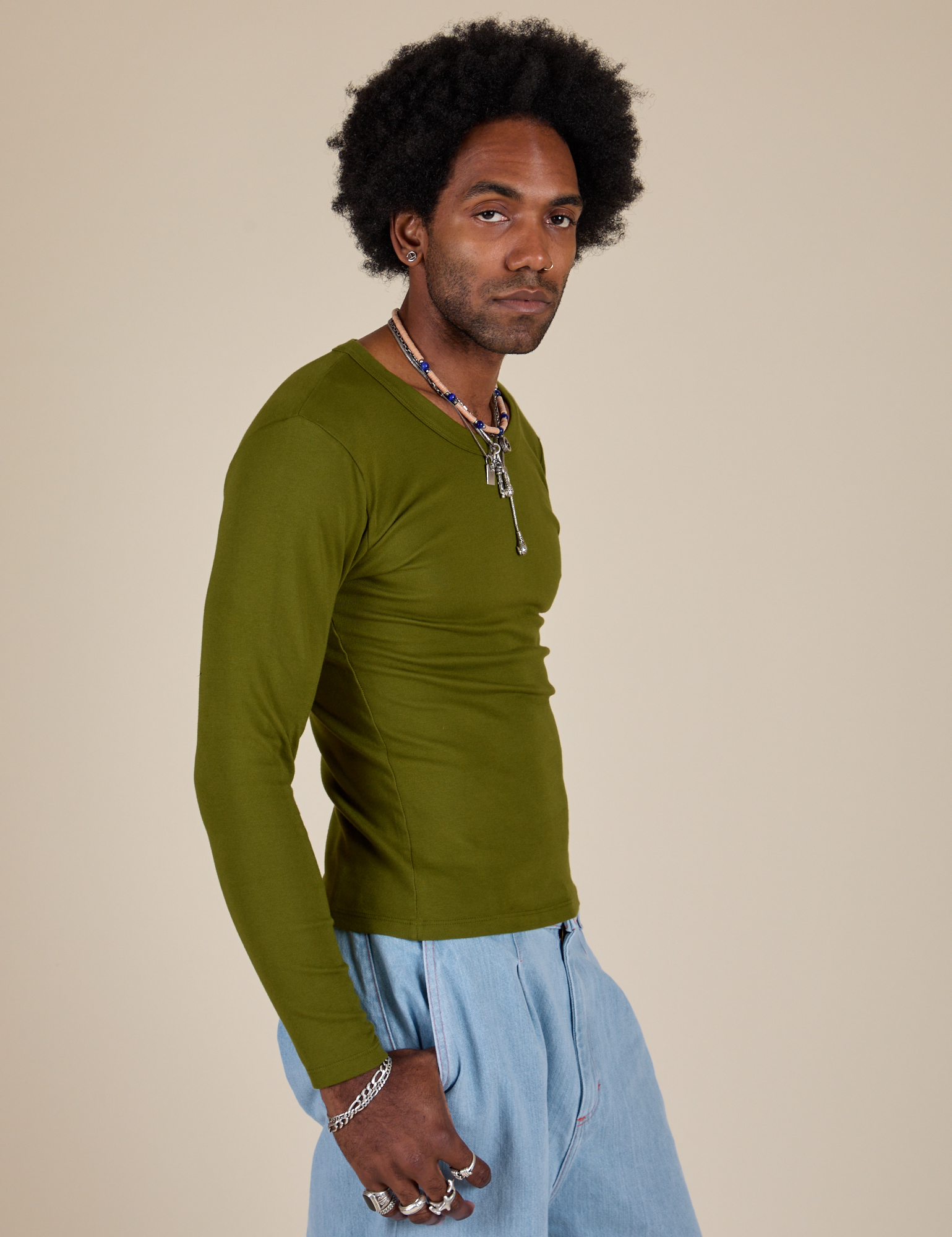 Long Sleeve Baby Tee in Summer Olive side view on Jerrod