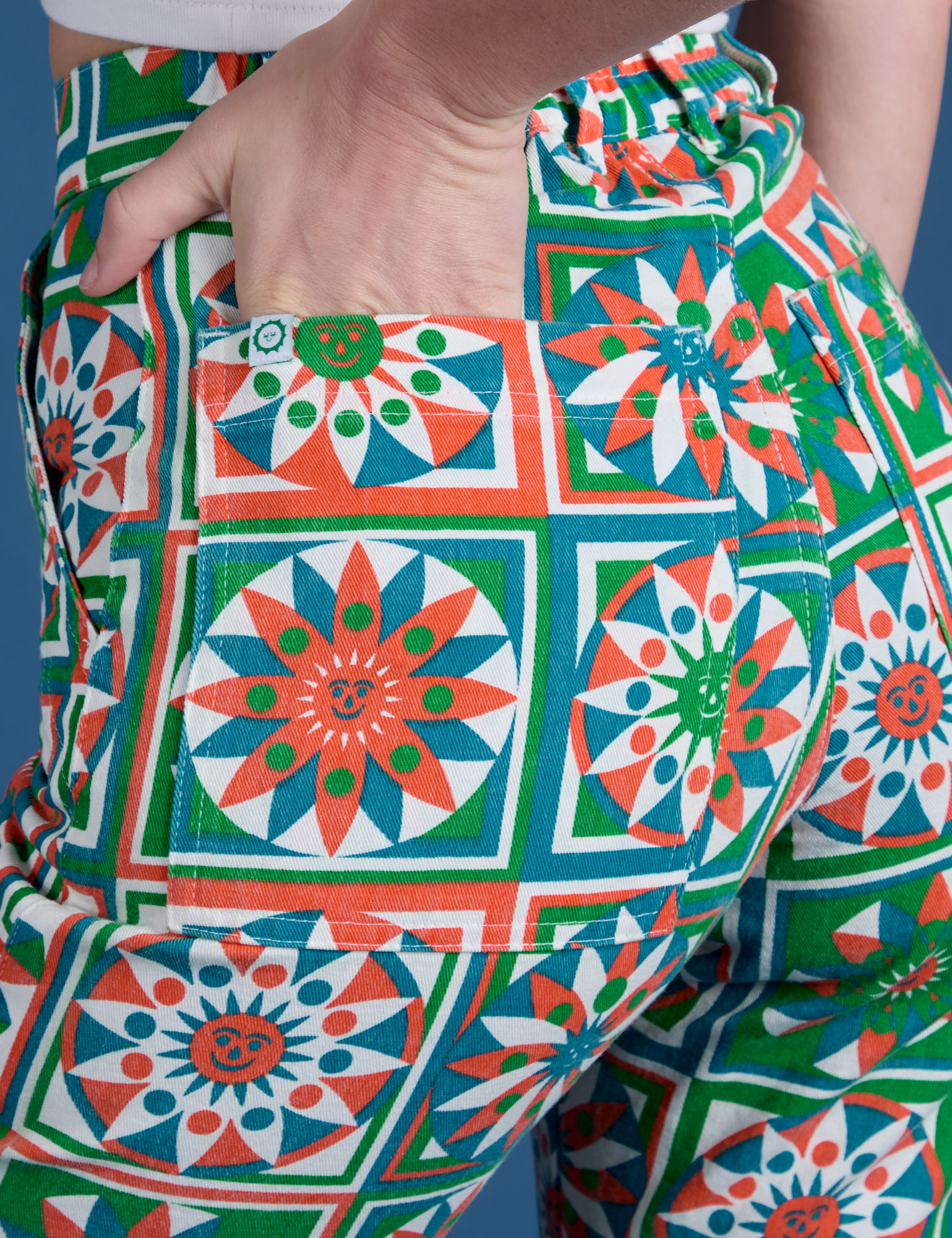 Close up of Alex's hand in the back pocket of Work Pants in Quilt Print
