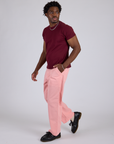 Angled front view of Work Pants in Baby Pink and red wine Organic Vintage Tee on Isaac
