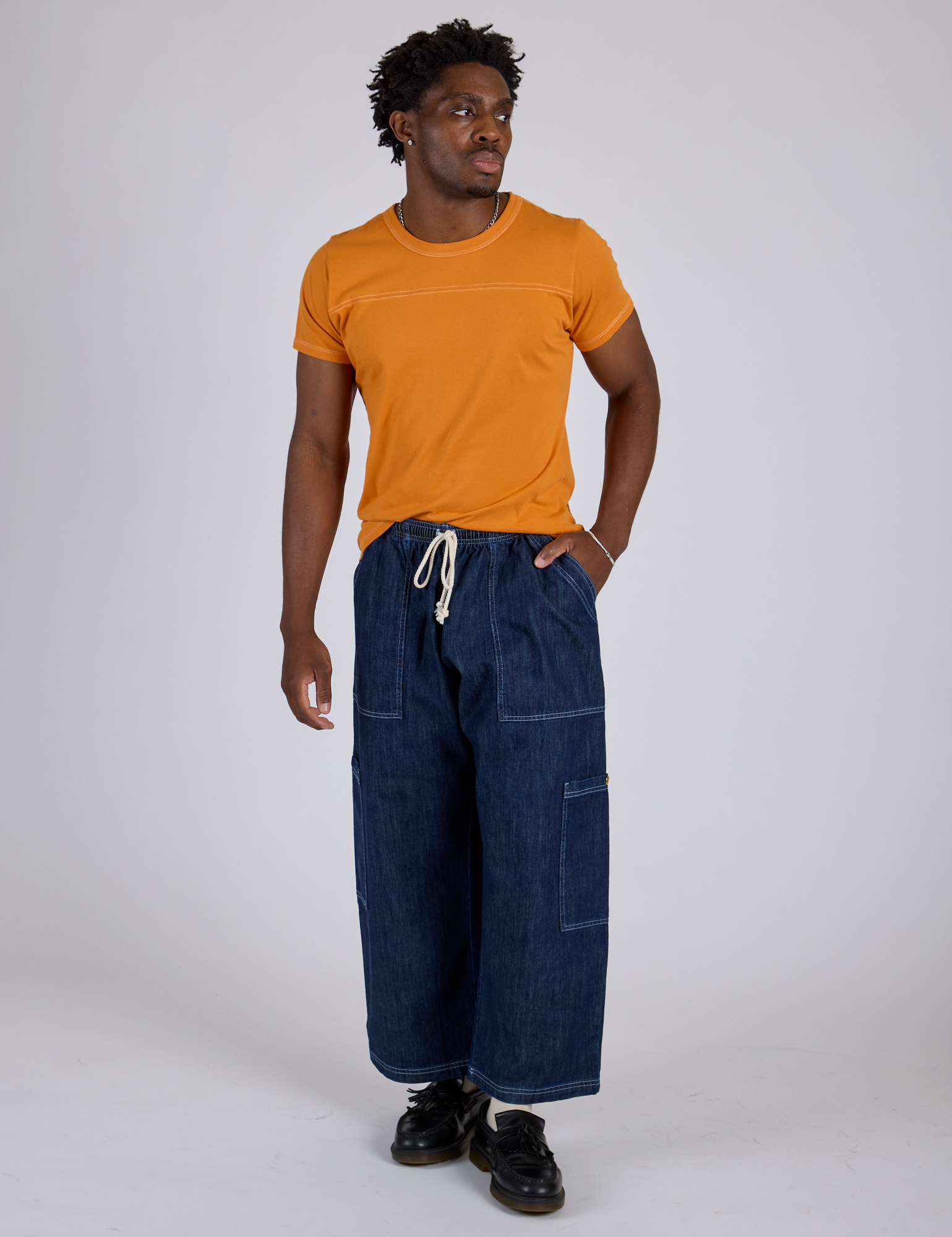 Jr. Varsity Tee in Creamsicle Orange and dark wash Denim Drop Pocket Pants on Isaac