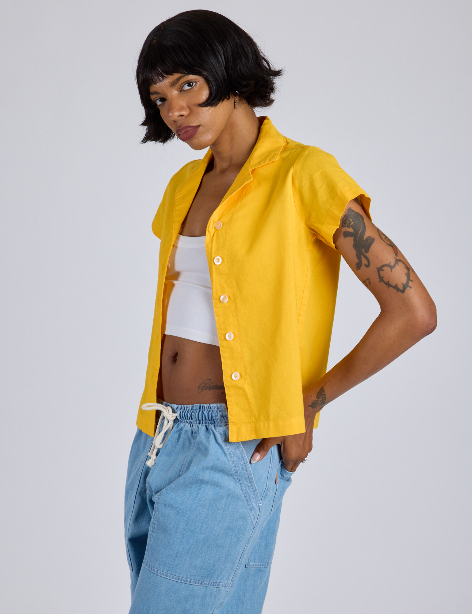 Angled front view of Pantry Button-Up in Sunshine Yellow on Kira