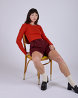 Pleated Trouser Shorts in Red Wine and mustang red Long Sleeve Gingham Baby Tee worn by Alex