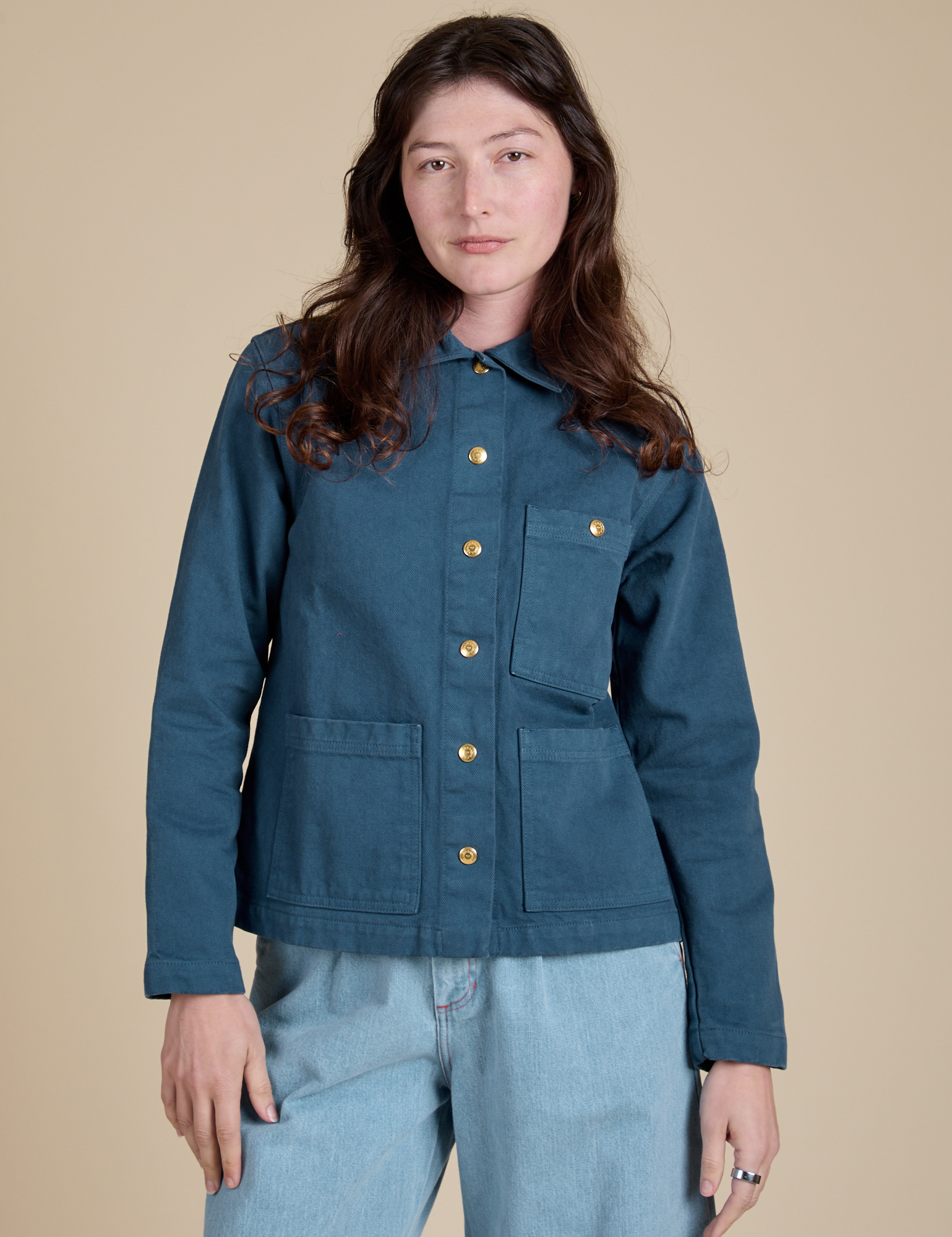 Alex is wearing a buttoned up Denim Work Jacket in French Blue