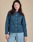Alex is wearing a buttoned up Denim Work Jacket in French Blue
