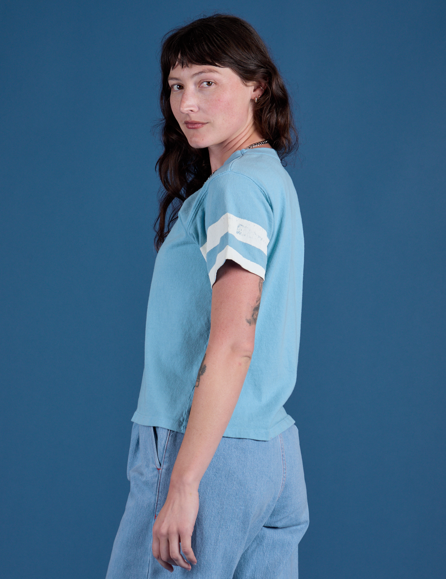 Painted Burly Tee in Baby Blue side view on Alex