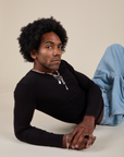 Jerrod is wearing Long Sleeve Baby Tee in Basic Black