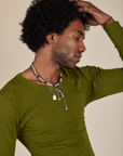 Long Sleeve Baby Tee in Summer Olive close up on Jerrod