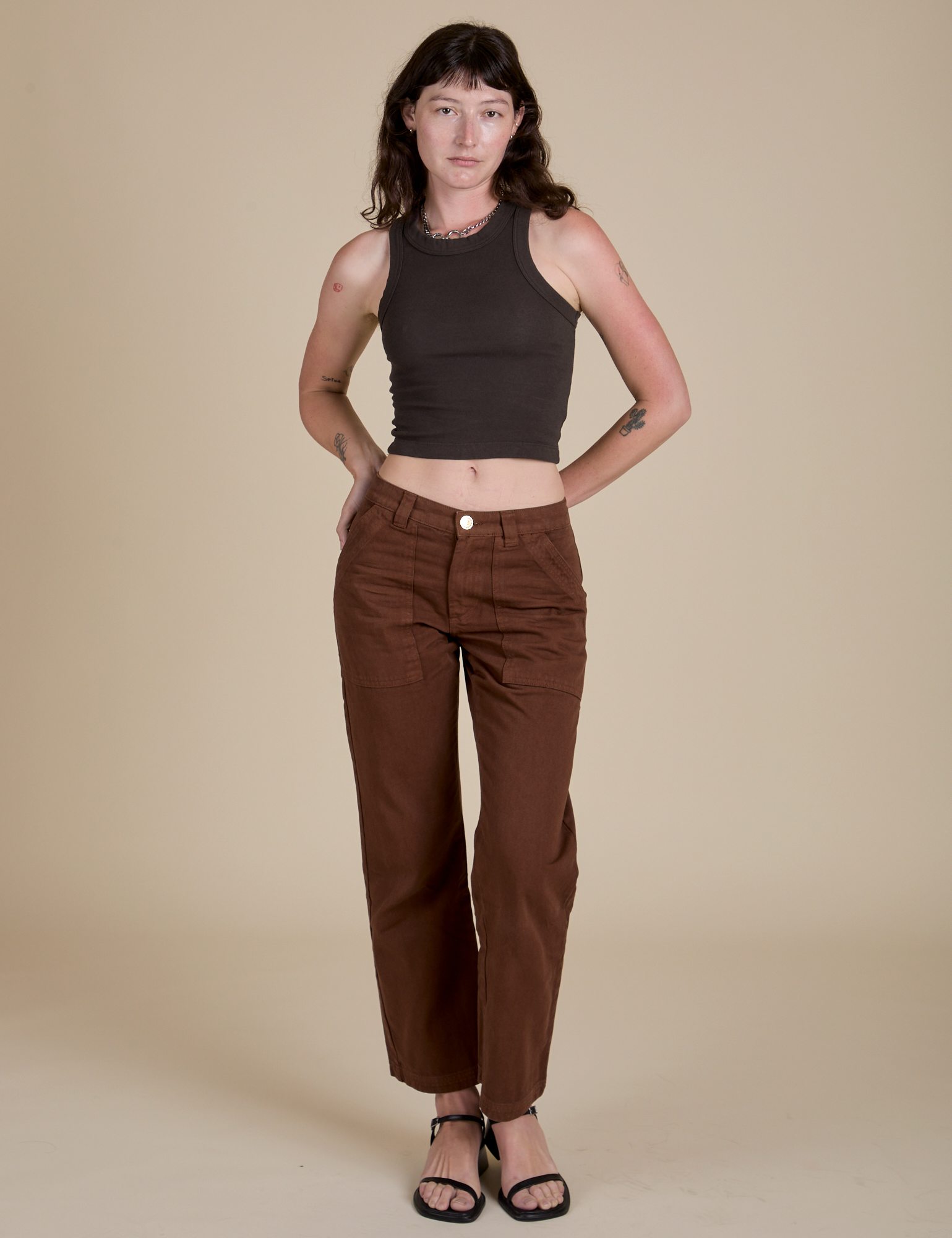 Alex is wearing Racerback Tank in Espresso Brown and fudgesicle brown Work Pants