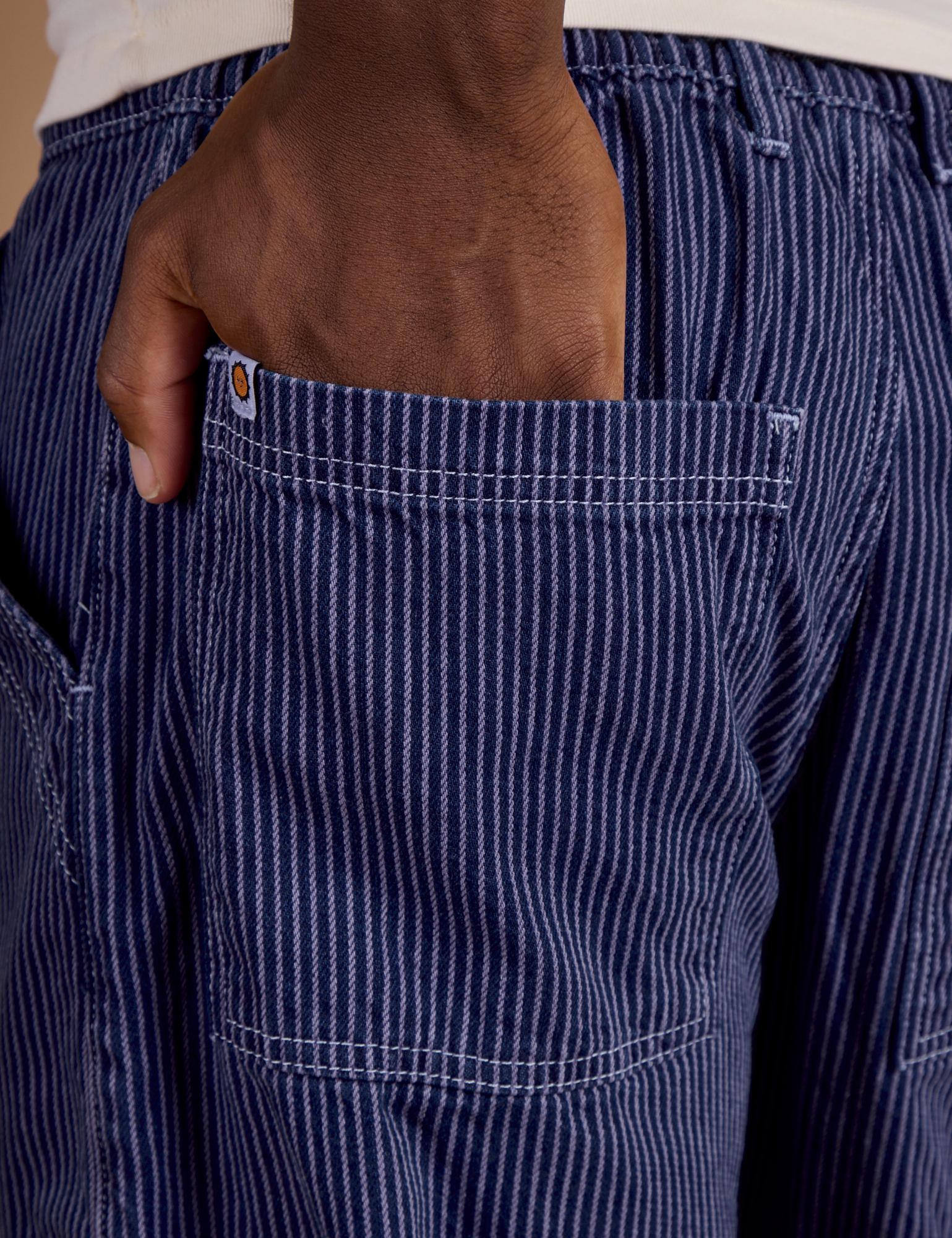 Close up of Isaac's hand in the back pocket of Railroad Denim Work Pants in Faded Grape Overdye