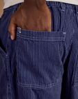 Close up of Isaac's hand in the back pocket of Railroad Denim Work Pants in Faded Grape Overdye