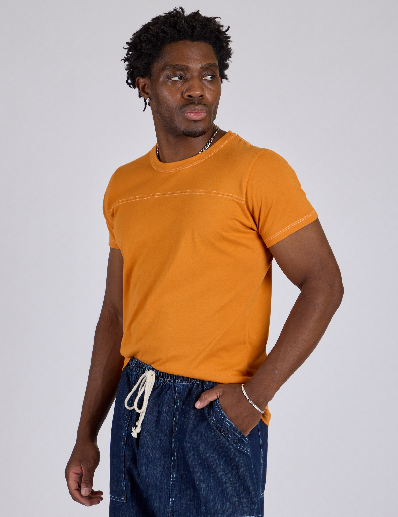 Angled Jr. Varsity Tee in Creamsicle Orange angled front view on Isaac