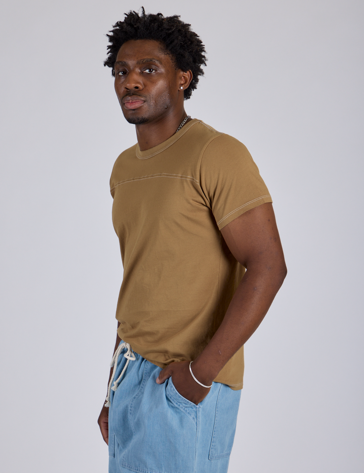 Jr. Varsity Tee in Desert Brown side view on Isaac