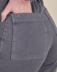 Close up of Alex's hand in the back pocket of Short Sleeve Jumpsuit in Washed Grey