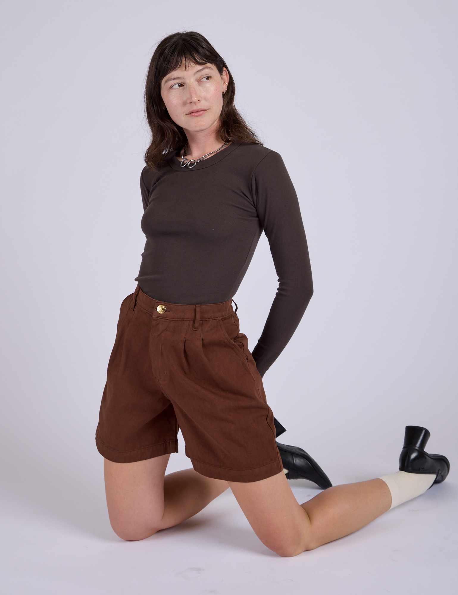 Pleated Trouser Shorts in Fudgesicle Brown and Long Sleeve Baby Tee in Espresso Brown worn by Alex