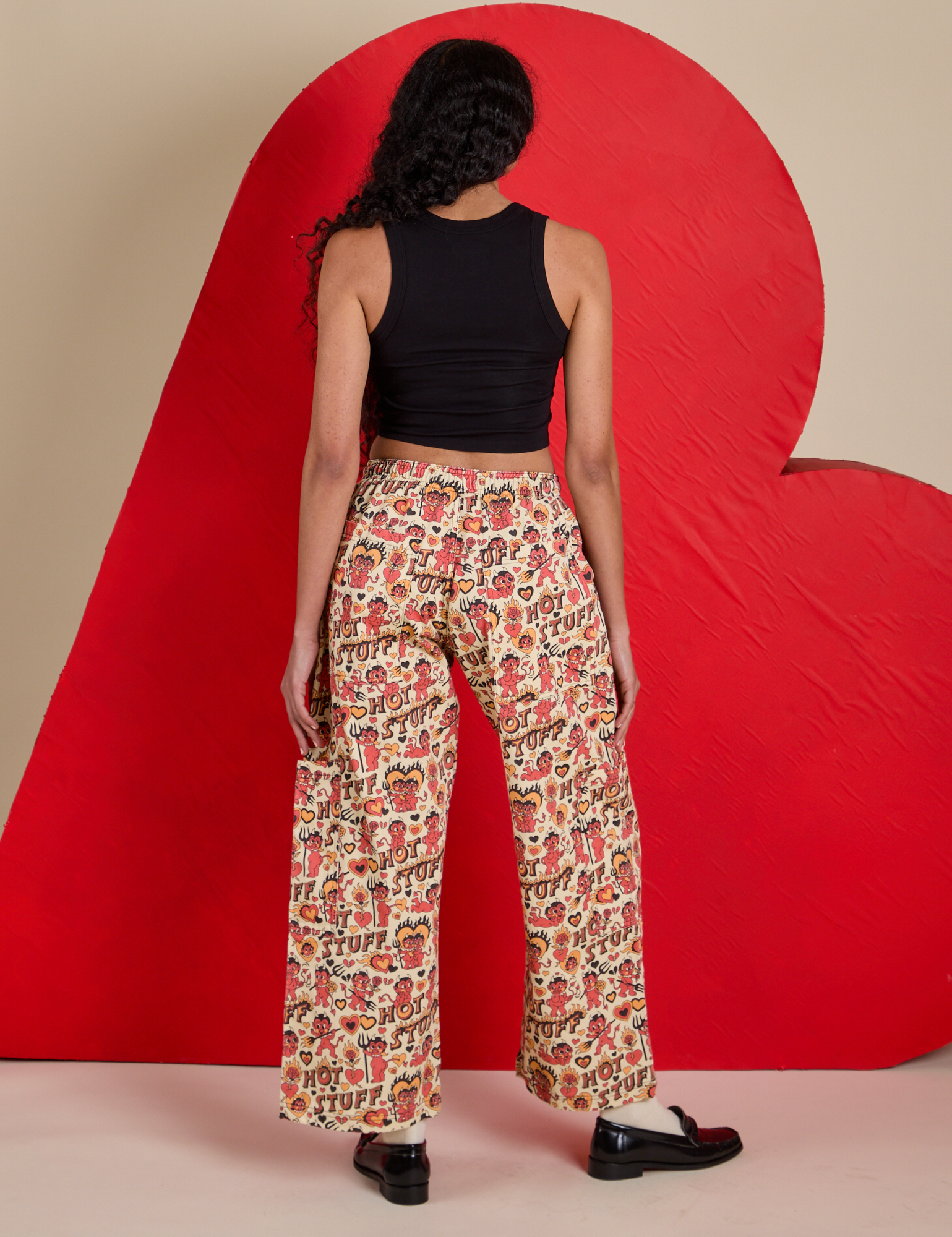 Back view of Hot Stuff Drop Pocket Cargo Pants and black Cropped Tank on Shahana