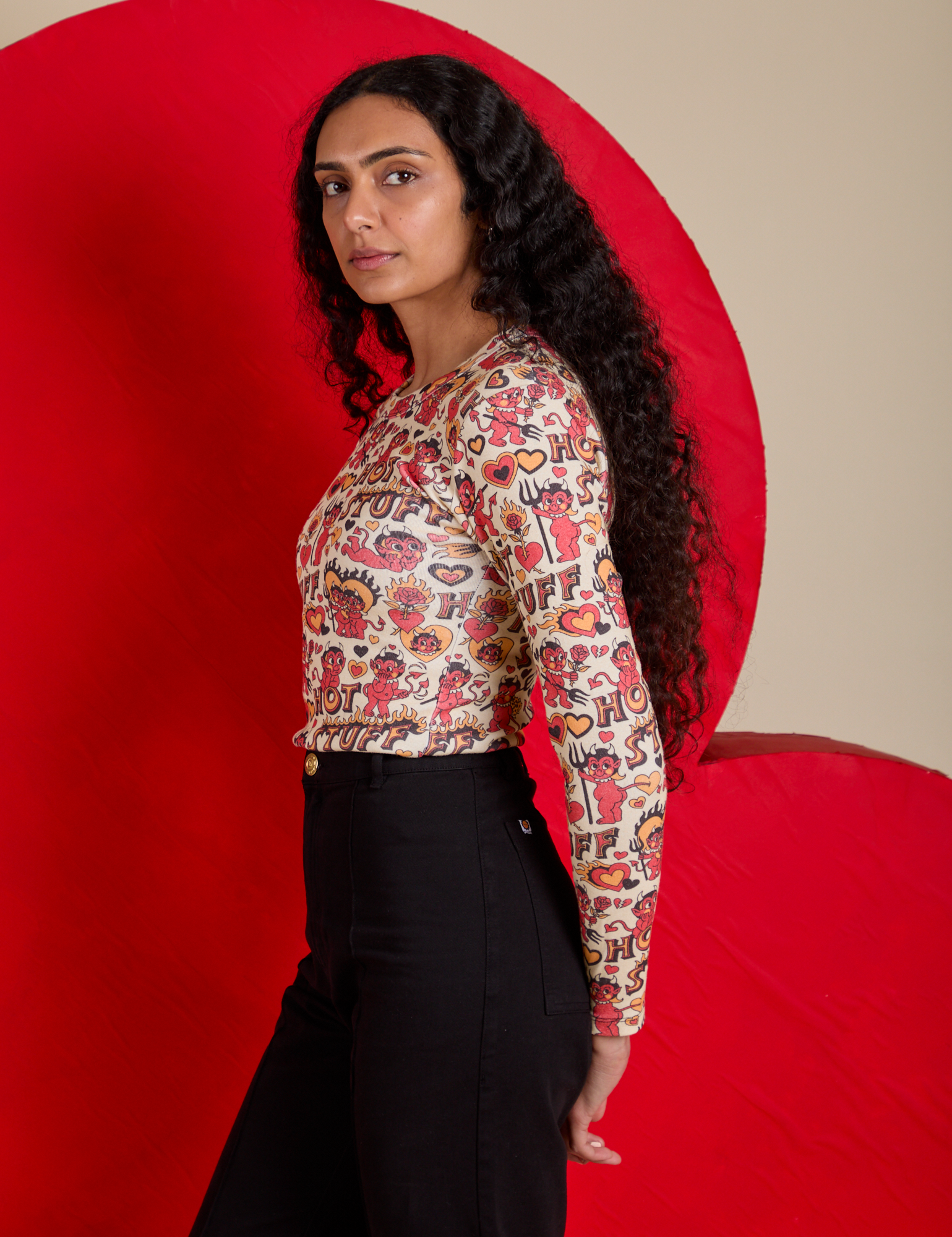 Side view of Long Sleeve Baby Tee in Hot Stuff Print on Shahana