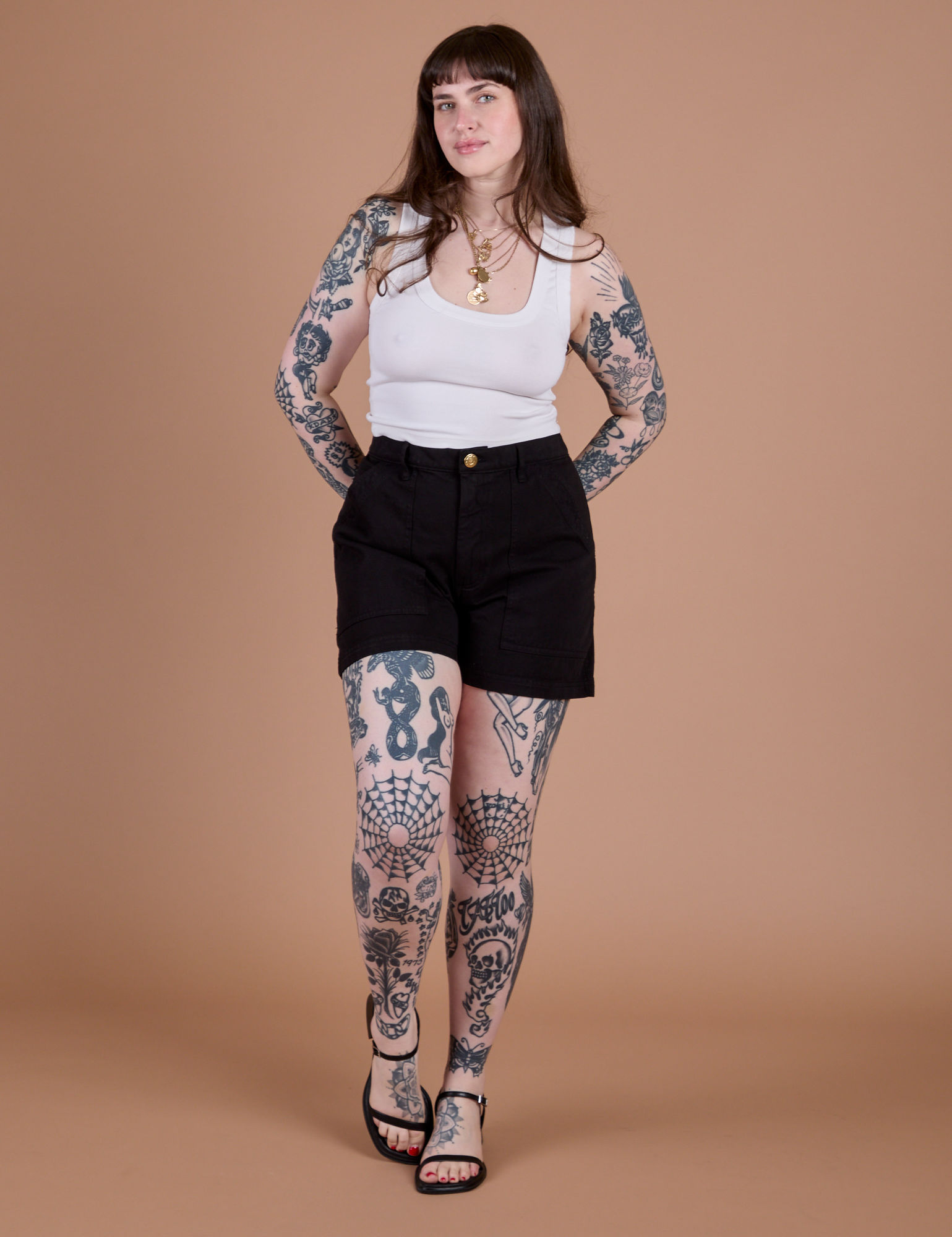 Sydney is wearing Classic Work Shorts in Basic Black and Cropped Tank in Vintage Tee White