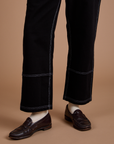 Carpenter Jeans in Black pant leg close up on Quinn