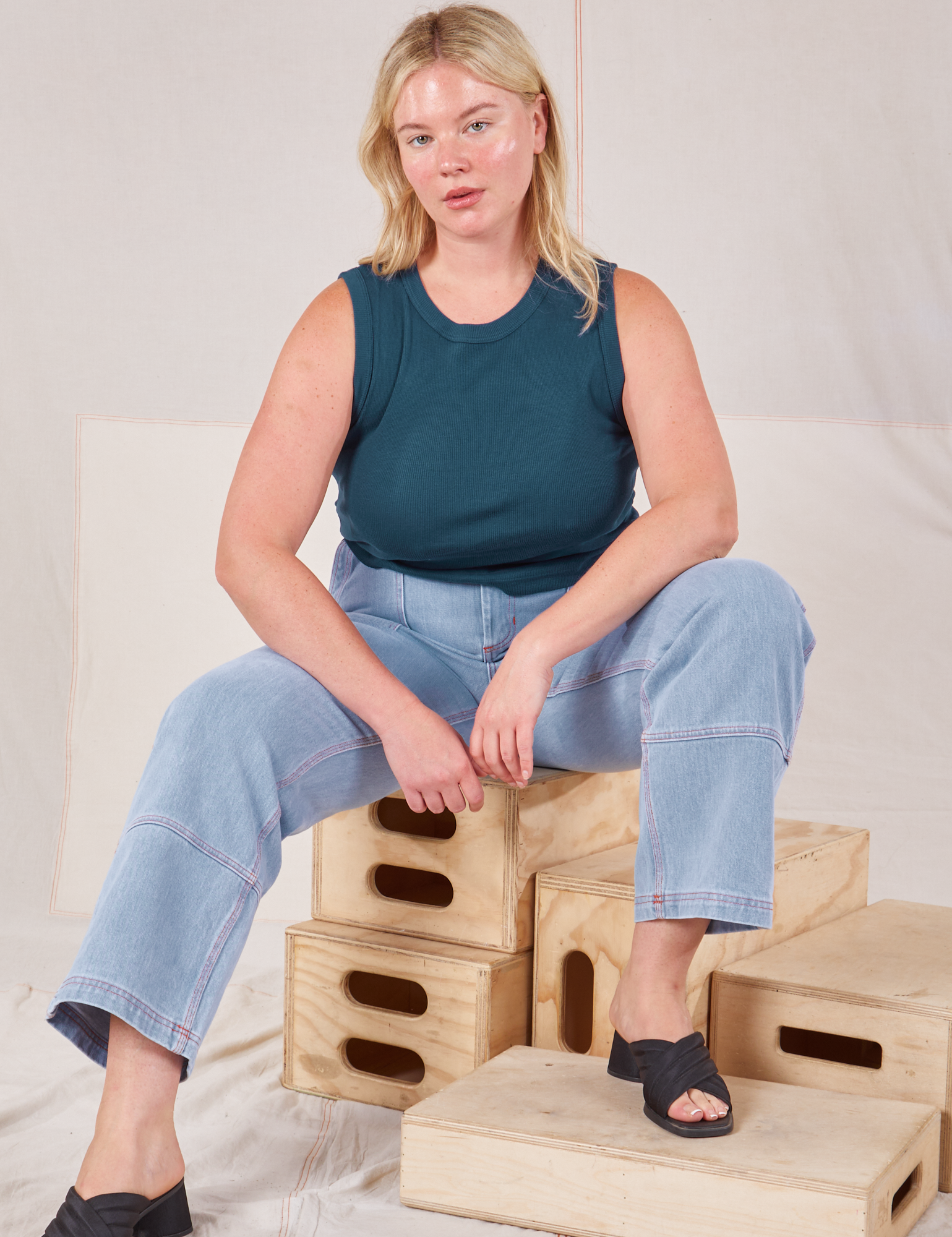 Lish is wearing Muscle Tee in Lagoon and light wash Carpenter Jeans
