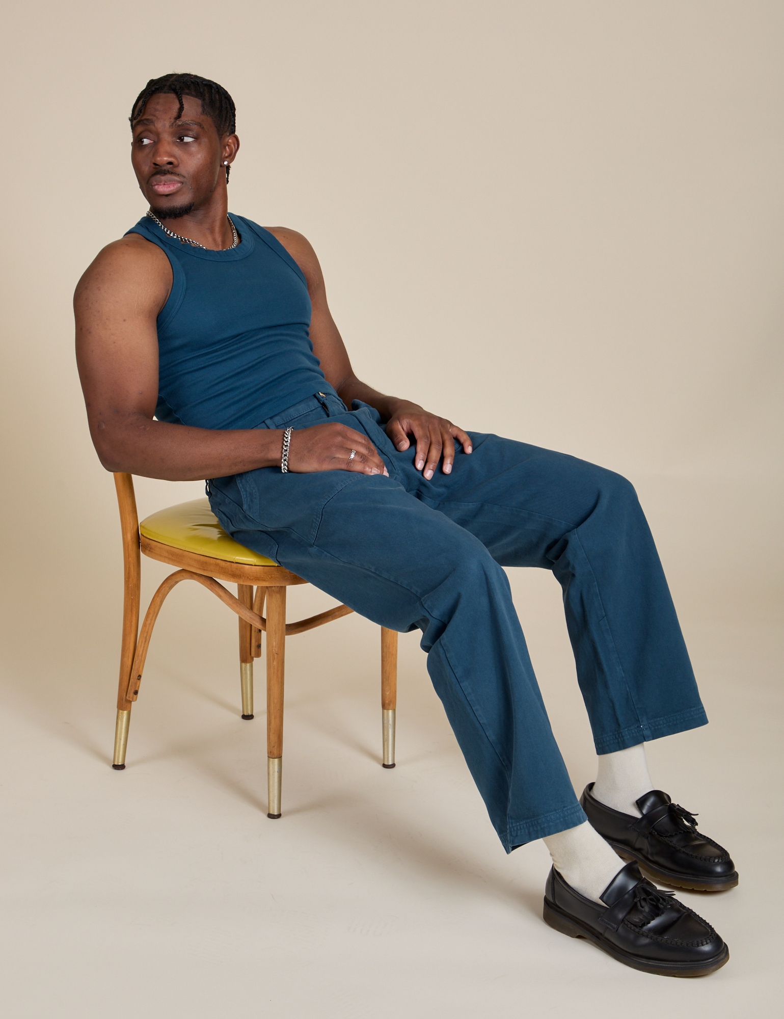 Isaac is wearing Racerback Tank in Lagoon and matching Work Pants
