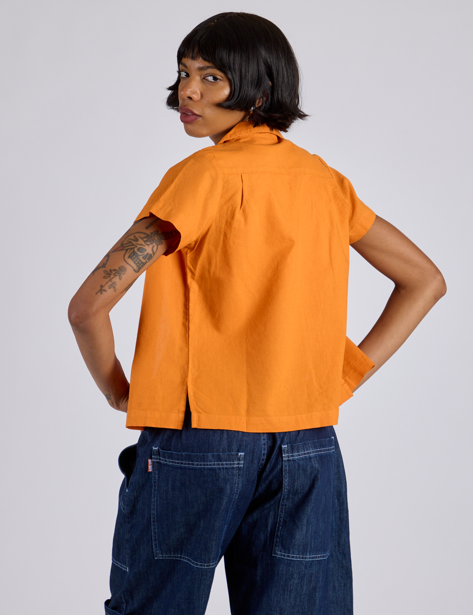 Pantry Button-Up in Creamsicle Orange back view on Kira