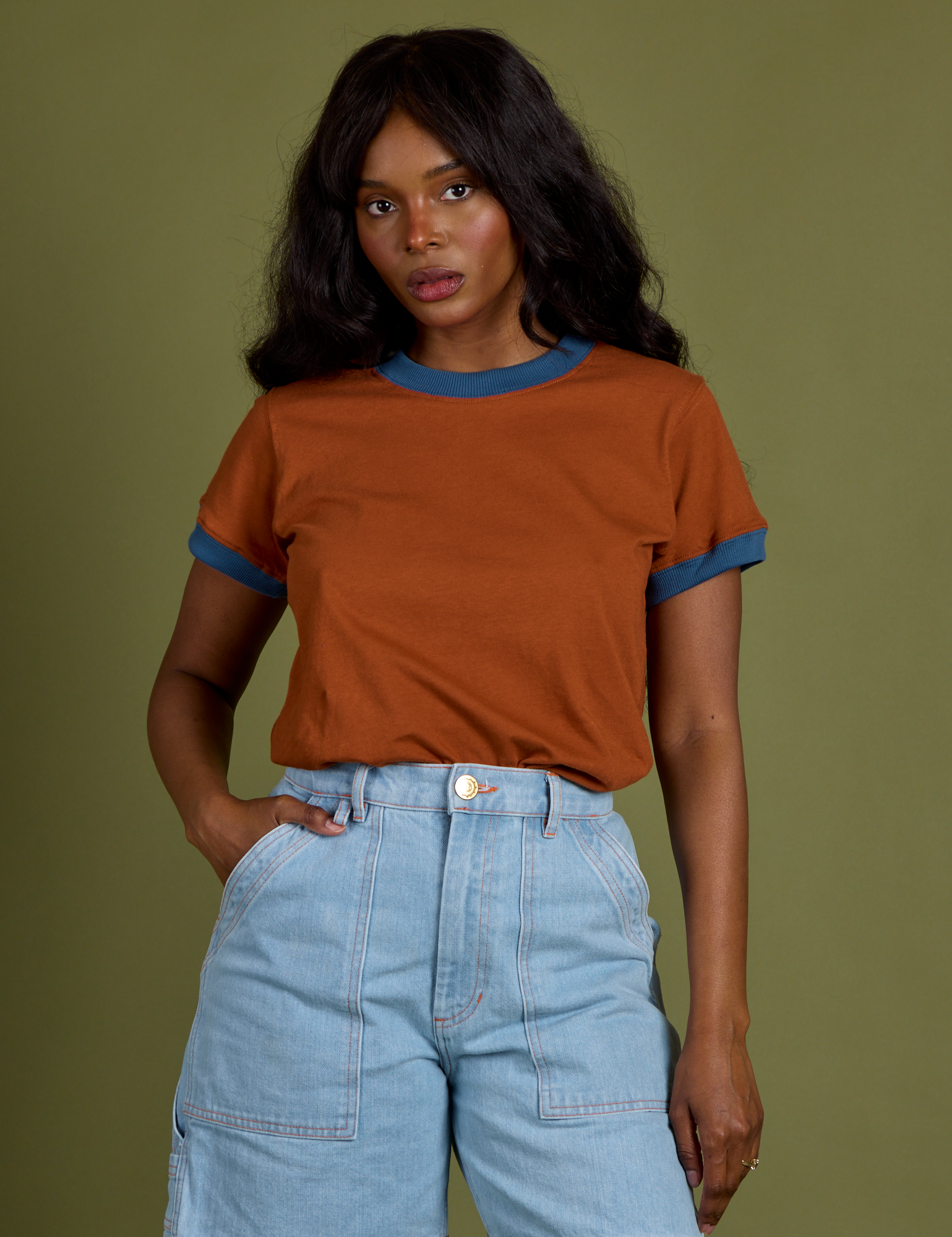 Kandia is wearing Vintage Ringer Tee in Burnt Terracotta tucked into light wash Carpenter Shorts