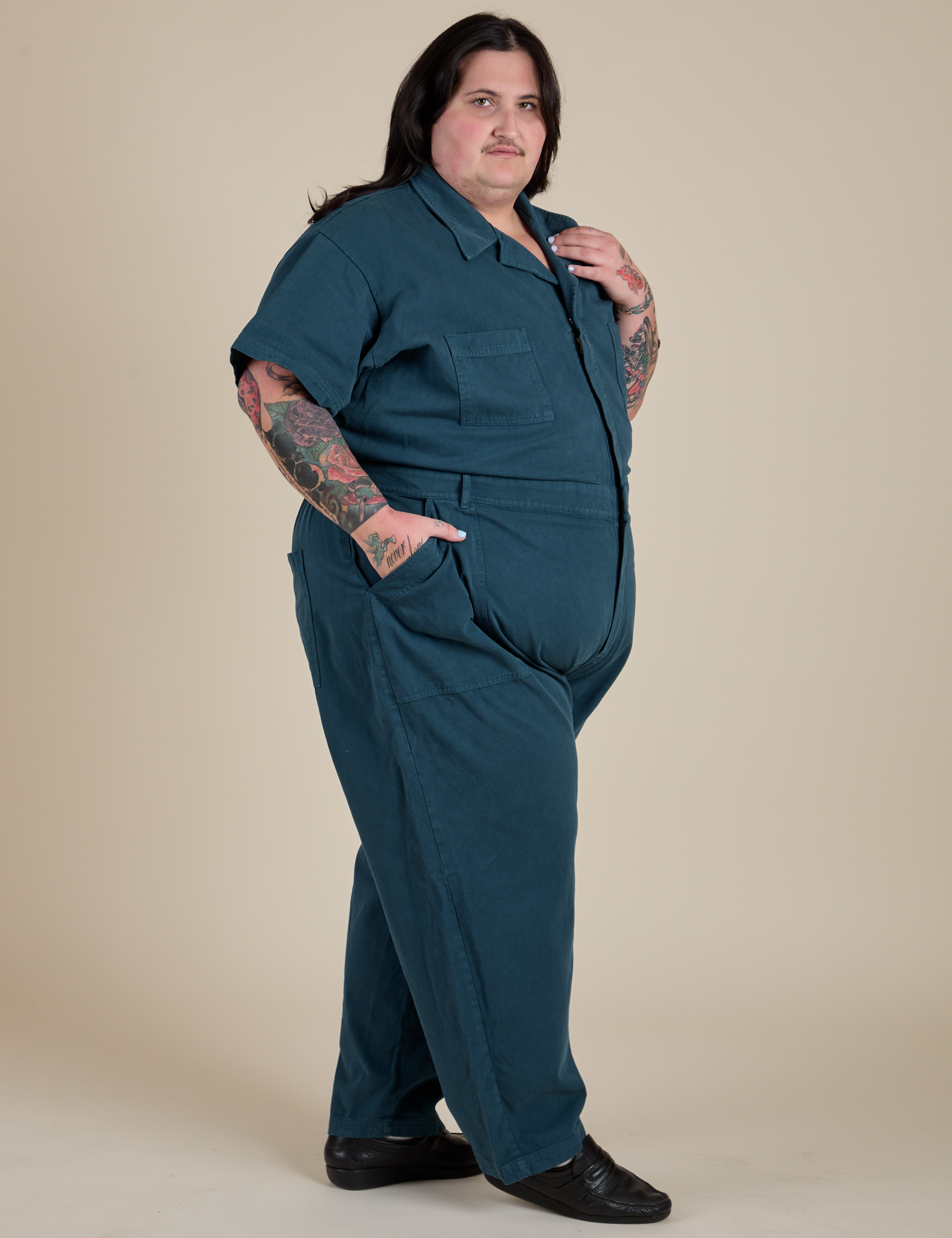Angled front view of Short Sleeve Jumpsuit in Lagoon on Sam