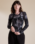 Alex is 5’8” and wearing P Long Sleeve Baby Tee in Ink Blot