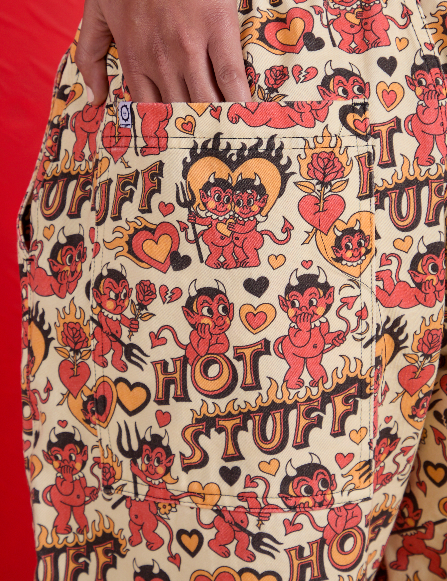Close up of Shahana's hand in the back pocket of Hot Stuff Drop Pocket Cargo Pants