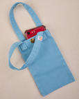 Phone tucked into baby blue Cell Phone Tote