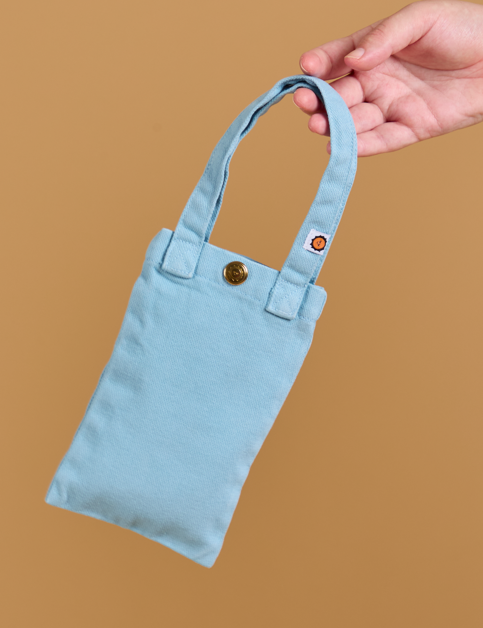 Cell Phone Tote in baby blue held by model