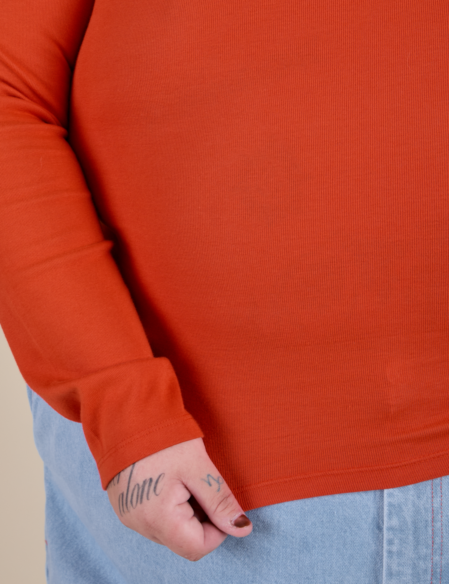 Long Sleeve Baby Tee in Chili Red bottom close up