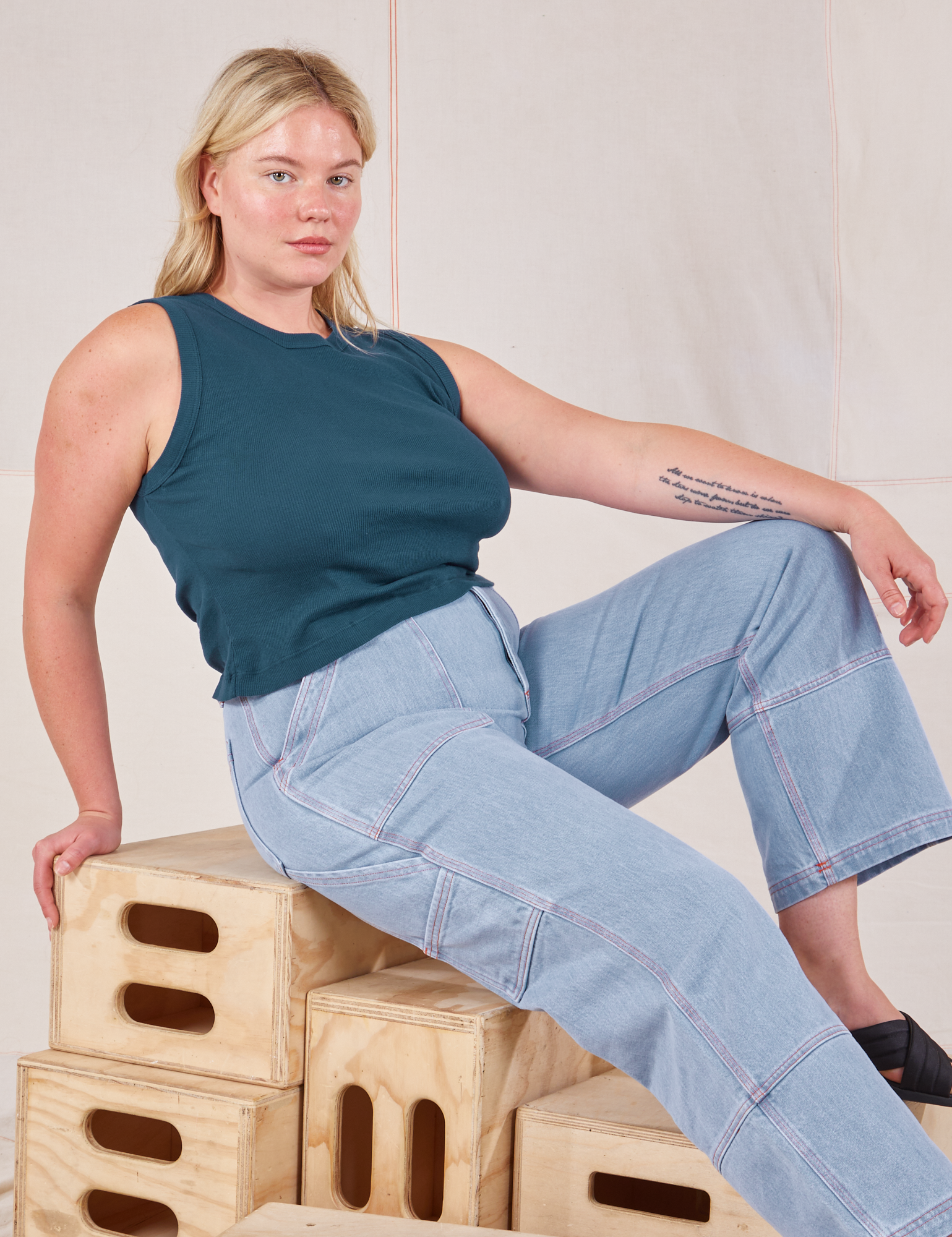 Lish is wearing Muscle Tee in Lagoon and light wash Carpenter Jeans